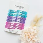 Colourful snap hair clips on display card