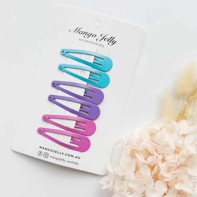 Colourful snap hair clips on display card