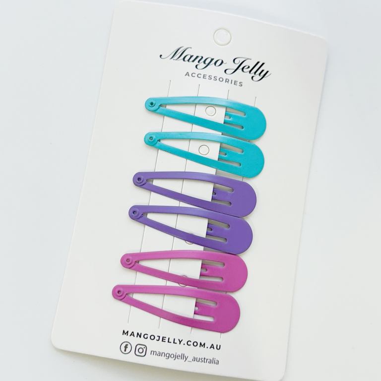 Colourful snap hair clips on display card