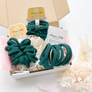 Green hair ties in gift box packaging
