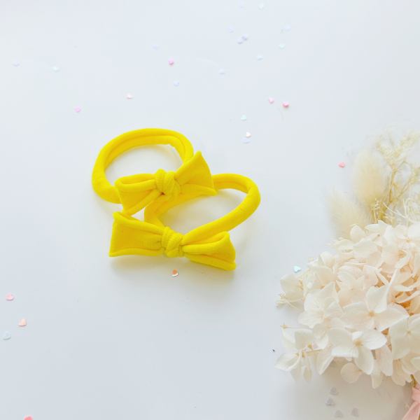 handmade simple bow metal free hair ties pop 1 pairs yellow Bright yellow bow headbands on white background