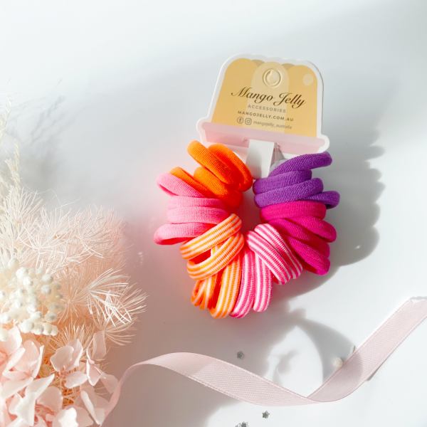 Colourful elastic hair ties on branded display card