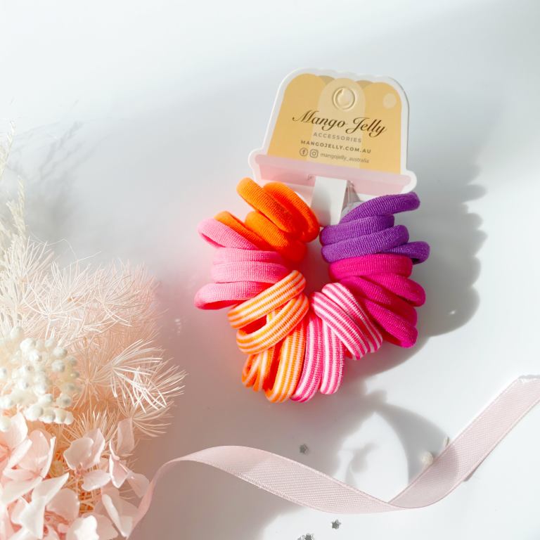 Colourful elastic hair ties on branded display card