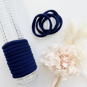 Navy blue hair ties on clear holder