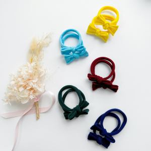 Colourful bow hair ties on white background