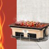 Portable charcoal grill with steaks and skewers cooking