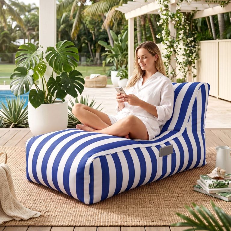 artiss outdoor bean bag chair cover (no filler) splash proof beanbag lounge sofacover stuffed animal storage bean bag cover for patio poolside relaxing, blue Woman relaxing on striped lounge using smartphone outdoors