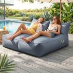 Two women relaxing on poolside inflatable lounge