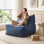 Woman relaxing with headphones on blue lounge chair