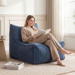 Woman reading book on blue lounge chair