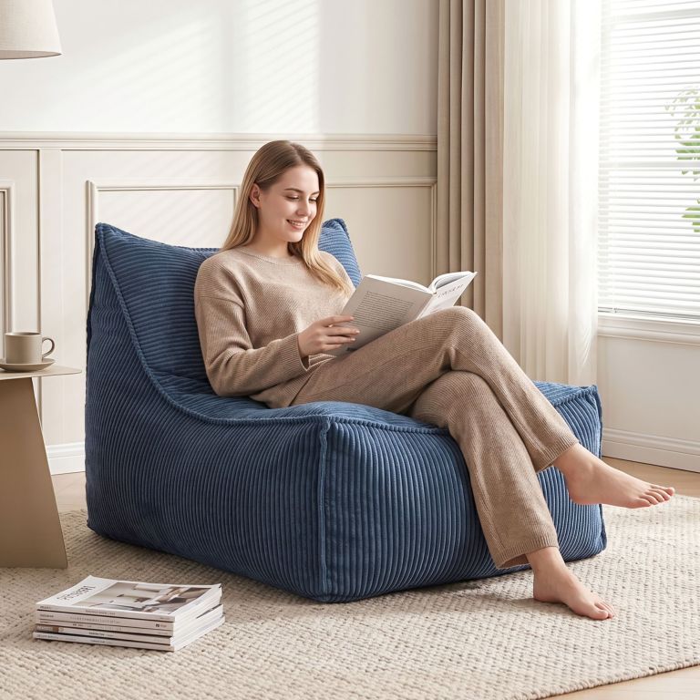 Woman reading book on blue lounge chair
