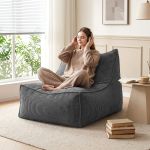 Woman relaxing on beanbag with headphones indoors