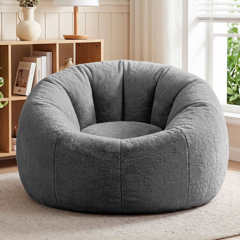 Plush grey round accent chair in bright living room