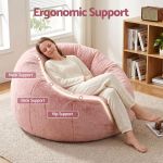 Woman relaxing on pink ergonomic bean bag chair