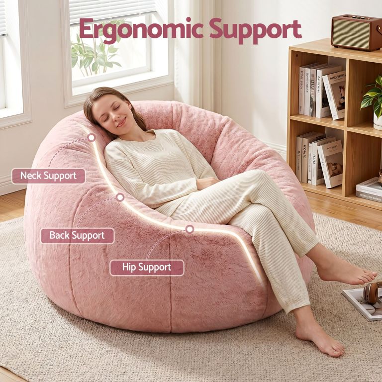 Woman relaxing on pink ergonomic bean bag chair