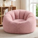 Plush pink round accent chair in bright living room