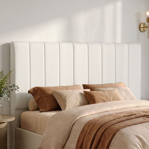 Modern bedroom with upholstered headboard and neutral bedding