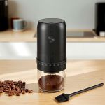 Black electric coffee grinder with ground coffee