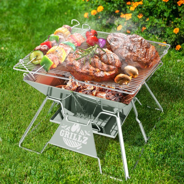 fpit bbq x cube 24634 06.jpg Portable charcoal grill with steaks and skewers