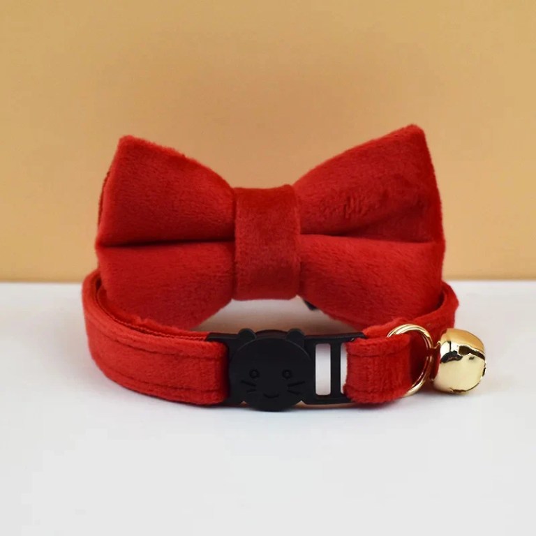 Red pet collar with bow and bell