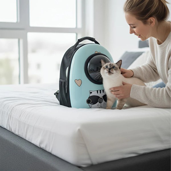 Woman placing cat into pet carrier backpack