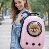 image 1 Woman carrying dog in pink pet backpack