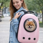 Woman carrying dog in pink pet backpack