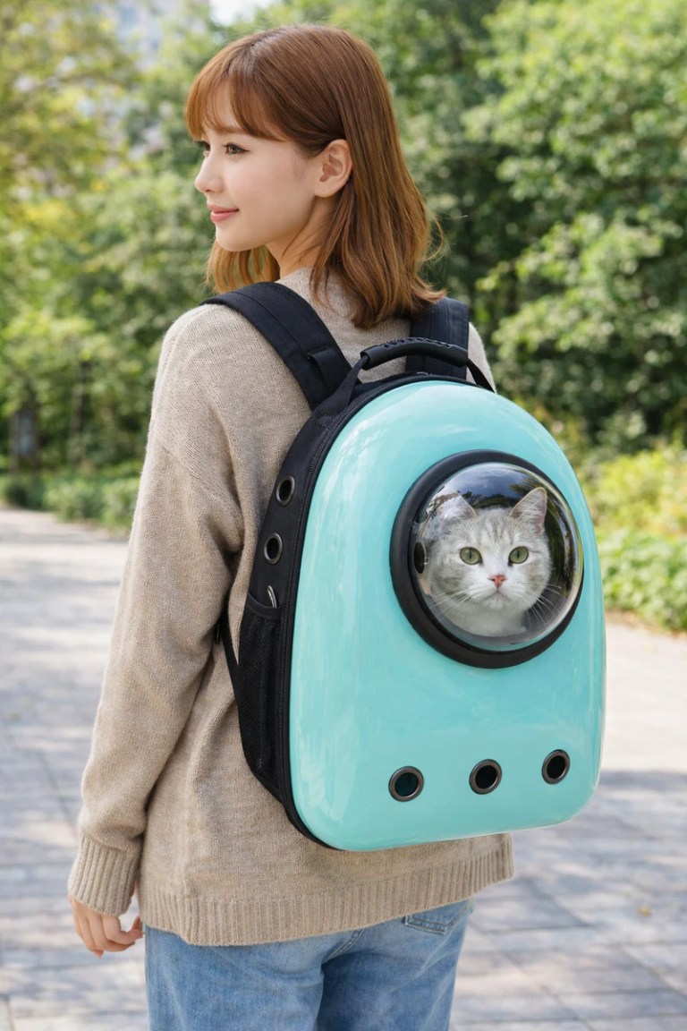 image 1 Woman carrying cat in bubble backpack outdoors