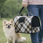 Small fluffy dog beside plaid pet carrier