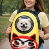 Woman carrying fluffy dog in yellow pet backpack