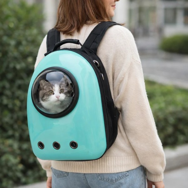 image 2 Woman carrying cat in teal backpack carrier