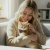 image 3 Woman cuddling ginger kitten wearing bow tie