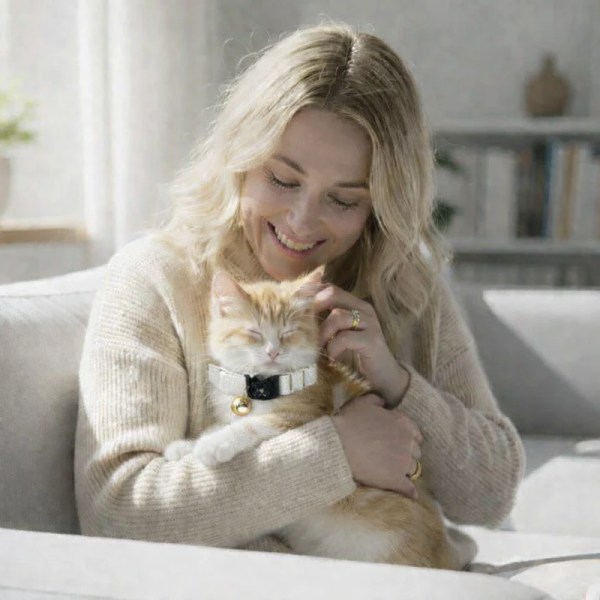 image 3 Woman cuddling ginger cat on sofa