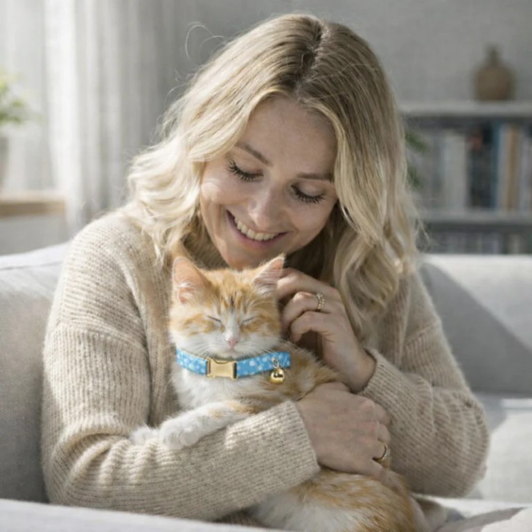 image 4 Woman cuddling ginger kitten on sofa