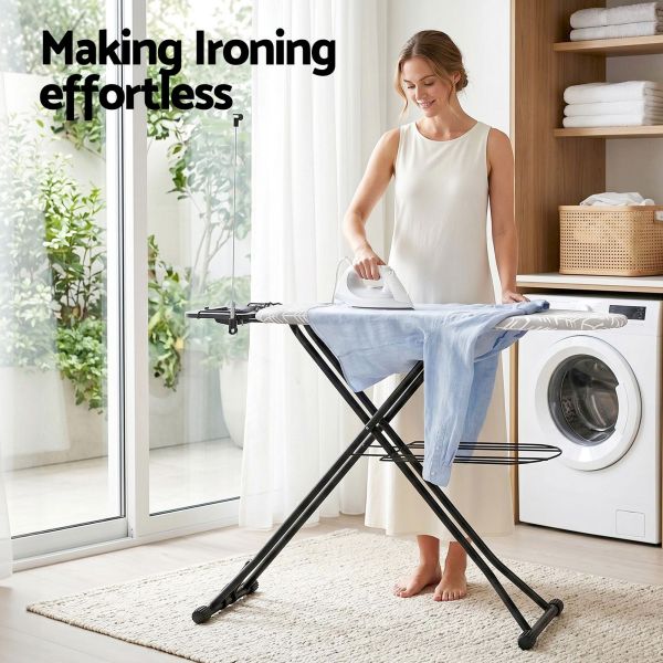 Woman ironing shirt in bright laundry room