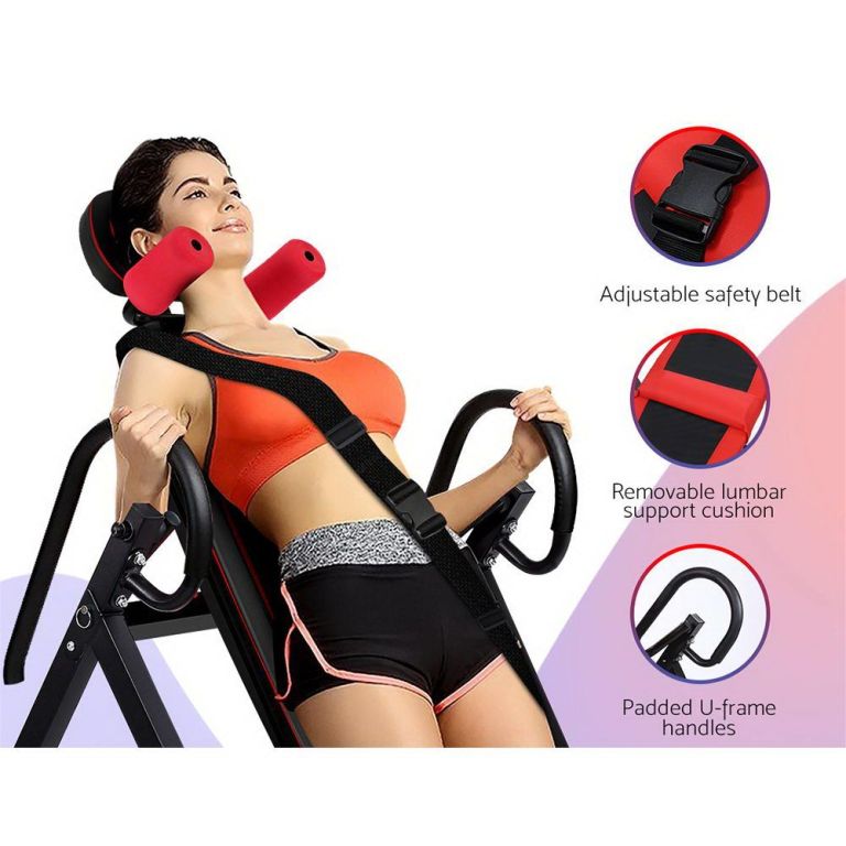 Woman using inversion table with safety straps