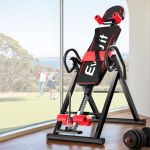 Black and red inversion table near window