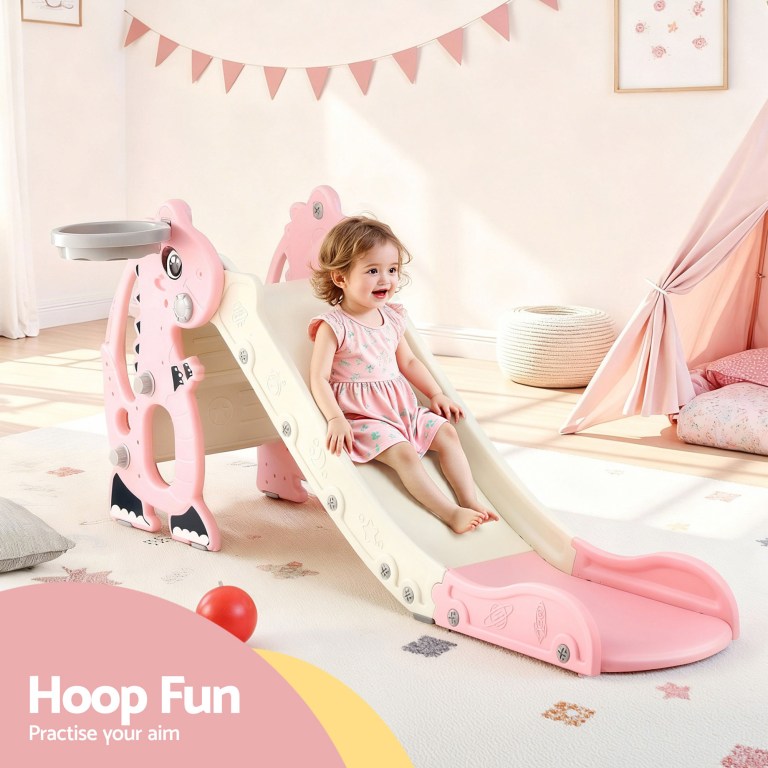 Toddler on pink indoor slide with hoop