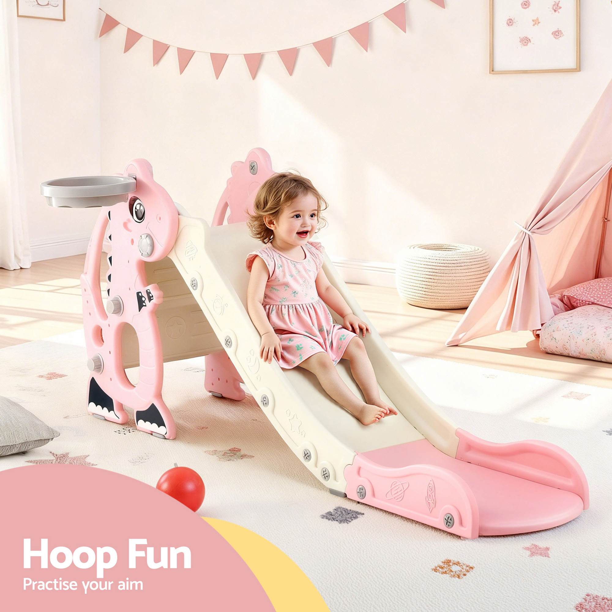 Toddler on pink indoor slide with hoop