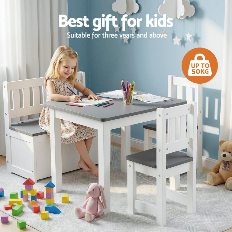 Young girl drawing at kids table set