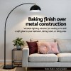 Black arc floor lamp over modern sofa