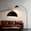 Modern black floor lamps over leather sofa