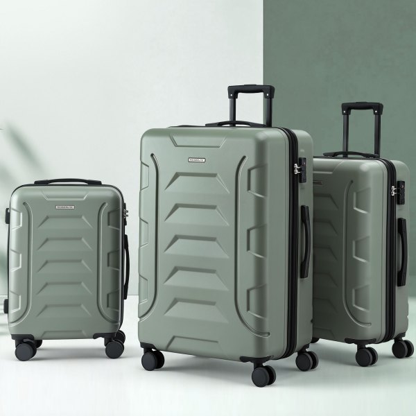 Three sage green hard-shell suitcases with wheels