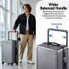 wanderlite 28 wide handle luggage suitcase travel tsa lock anthracite grey" Traveller with suitcase featuring wider balanced handle