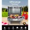 Portable stainless steel BBQ grill with food outdoors