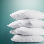 pillow micro 2m2f k 202502281438 00.jpg Stack of four white pillows on teal background