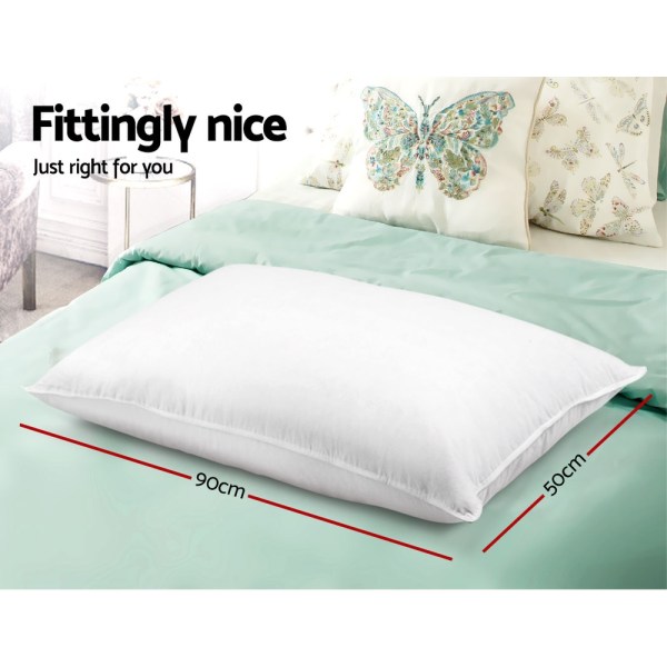 White pillow on mint bedspread with dimensions