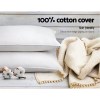 White cotton pillows with beige throw blanket
