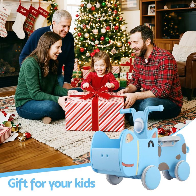 Family opening Christmas present by decorated tree
