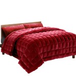 Red quilted doona on wooden bed